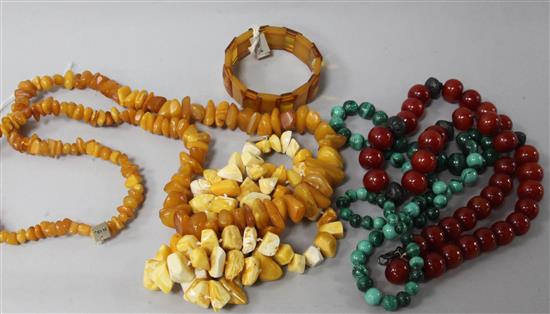 Two amber necklaces and a bracelet and two other necklaces.